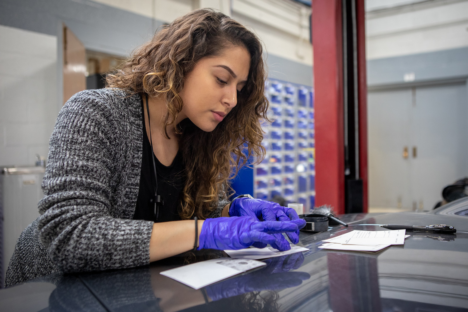 Students in the Department of Criminal Justice dust for fingerprints during a forensics lab class on February 19, 2019.